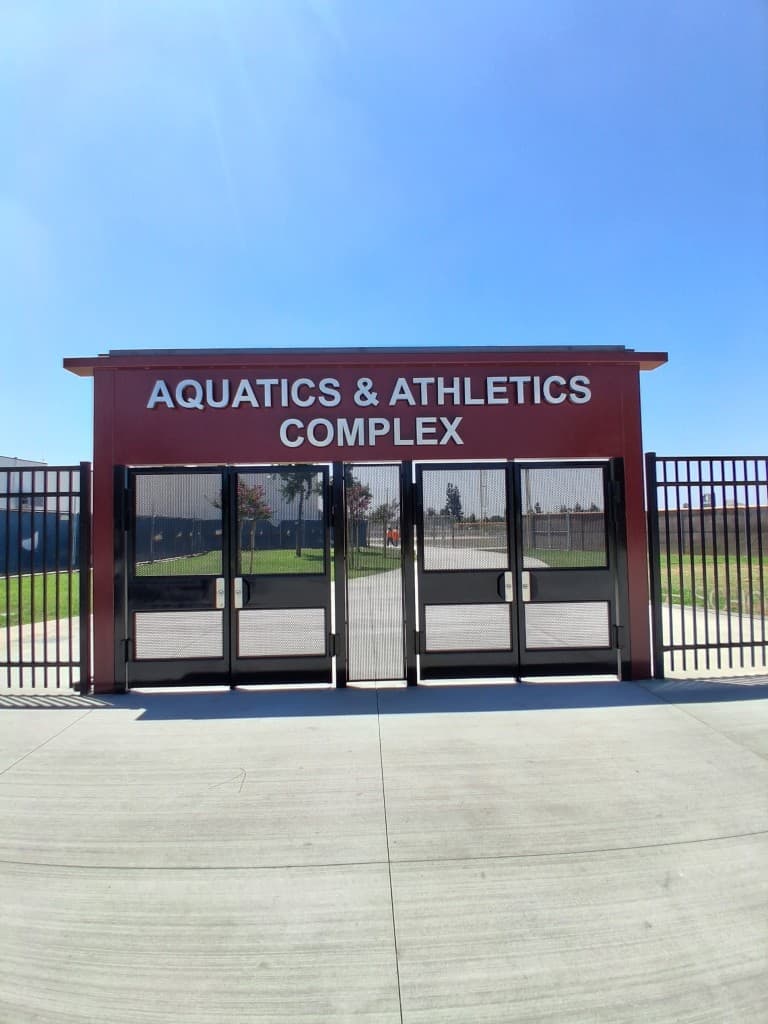 Mesh entry gates at an aquatics and athletics complex
