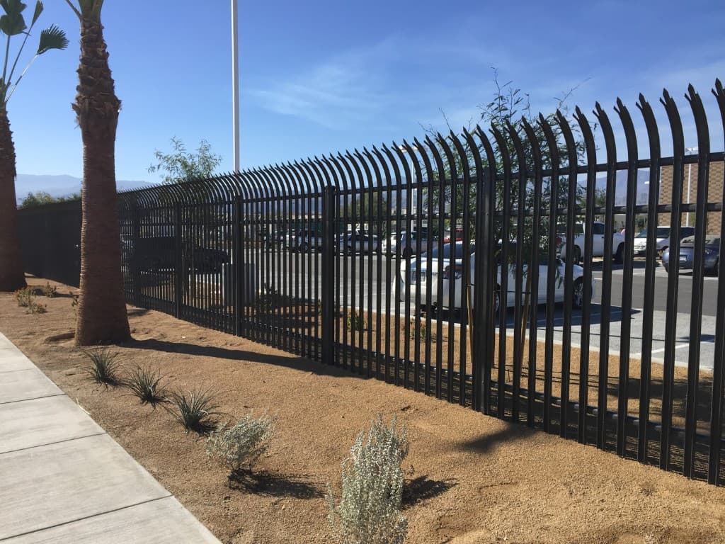 Curved-top palisade security fence in the desert